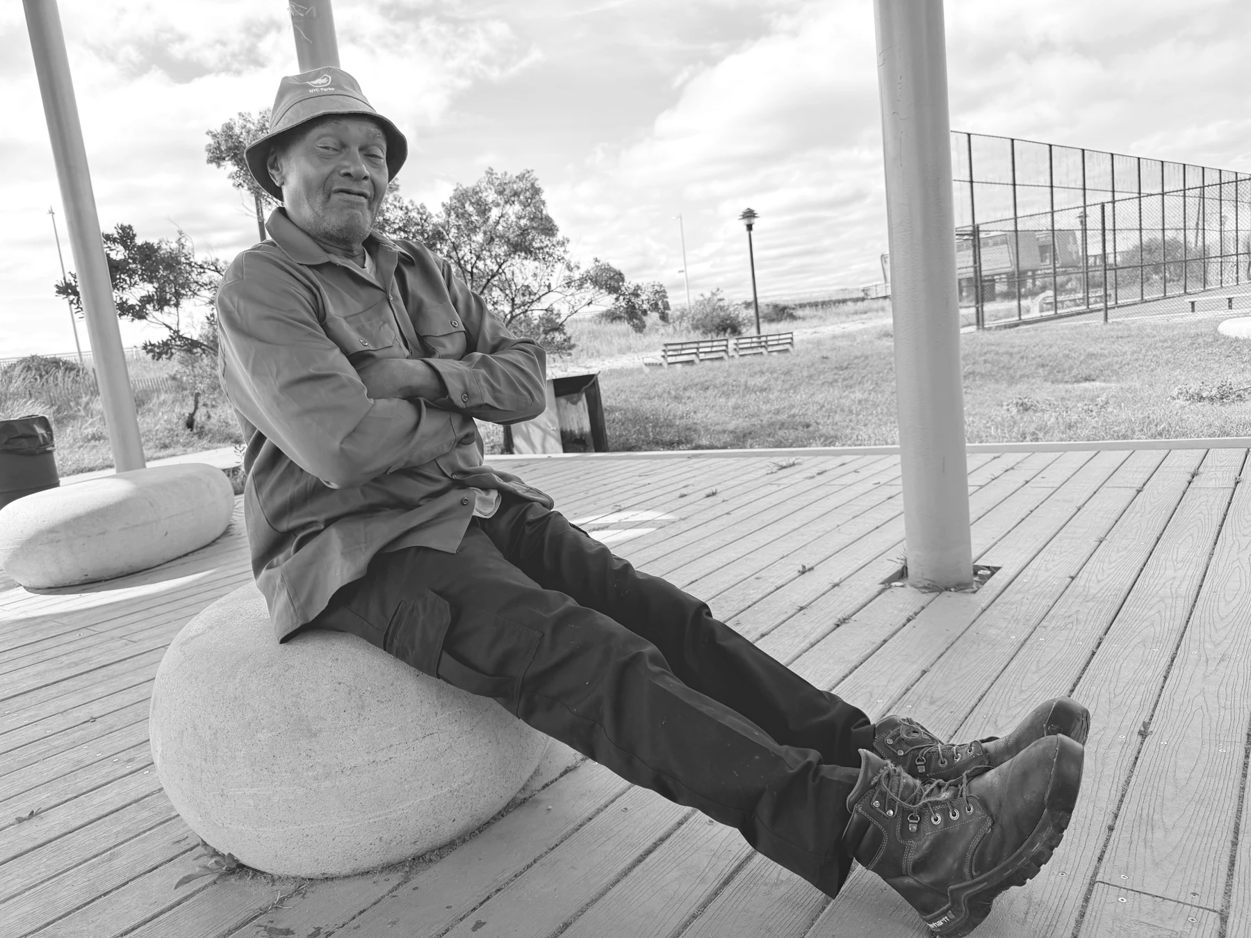 Kenny Harris seated outdoors in Queens